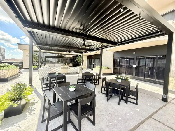 a view of a patio with dining table and chairs