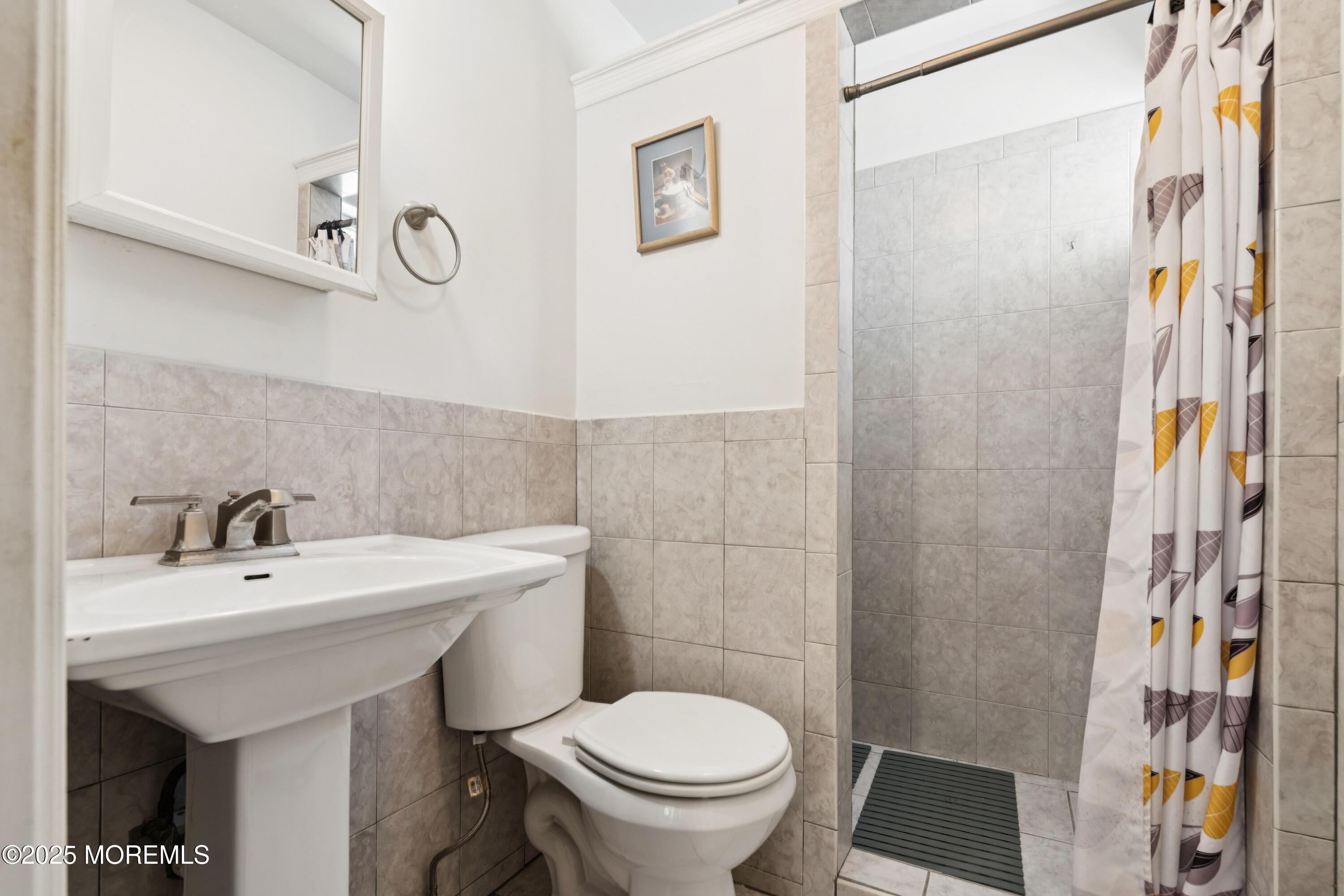 507 Riverside Drive South Brick, NJ 08723 - Photo 19 of 30 a bathroom with a sink a toilet and shower curtain