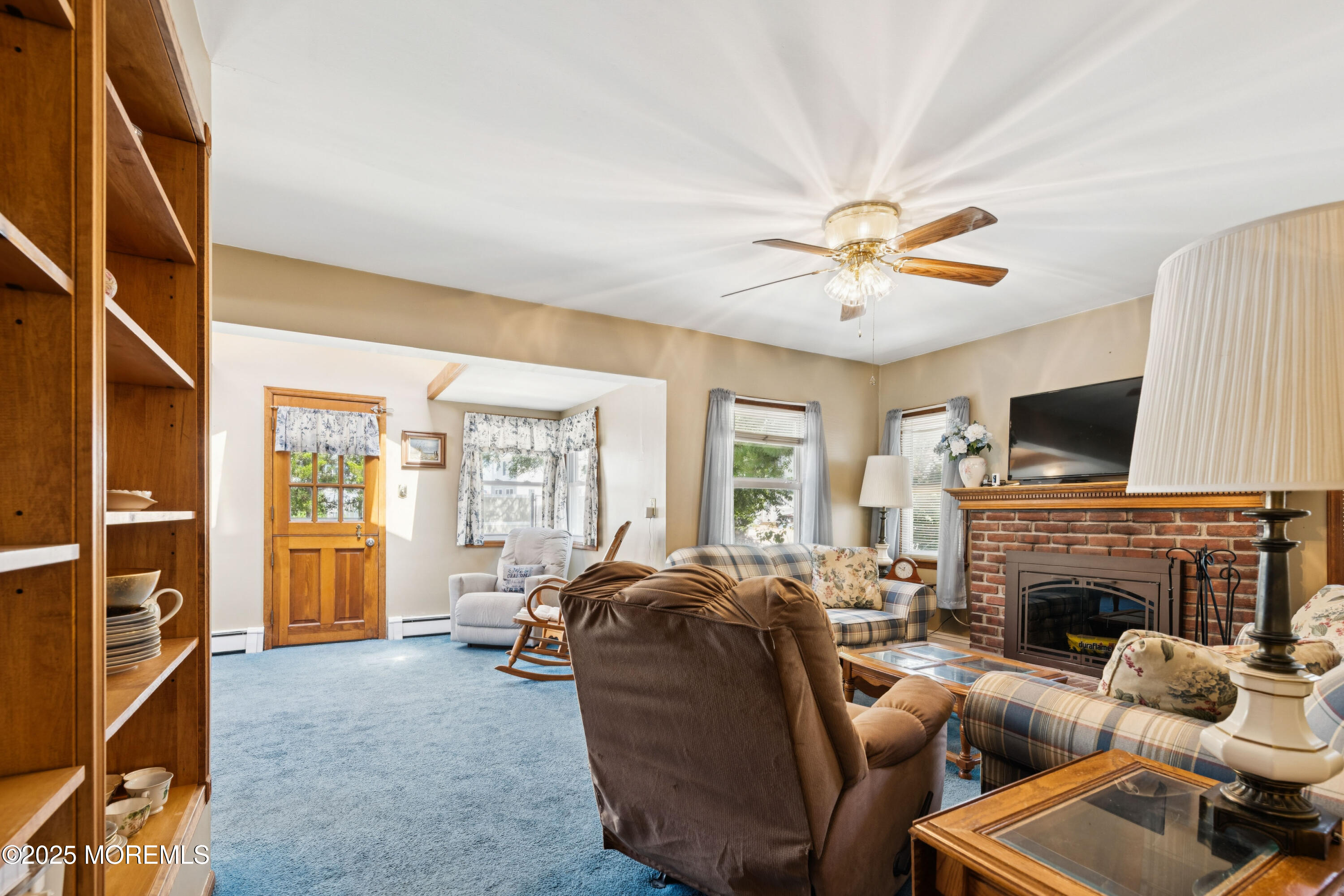 507 Riverside Drive South Brick, NJ 08723 - Photo 5 of 30 a living room with furniture a flat screen tv and a fireplace