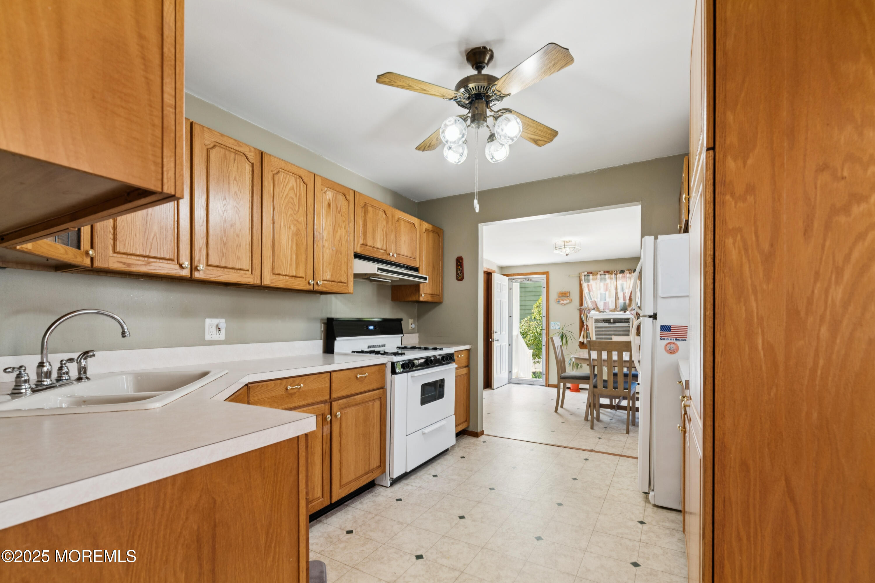 507 Riverside Drive South Brick, NJ 08723 - Photo 10 of 30 a kitchen with stainless steel appliances a sink a stove cabinets and a window