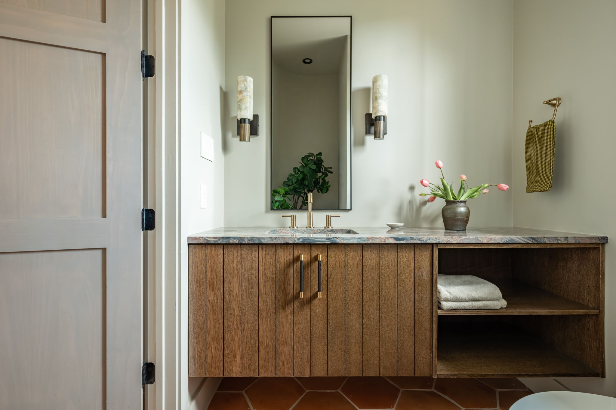 4713 Bolm Road Austin, TX 78702 - Photo 36 of 40 Floating vanity with slat-front cabinetry and an open shelving unit, complemented by a stone countertop