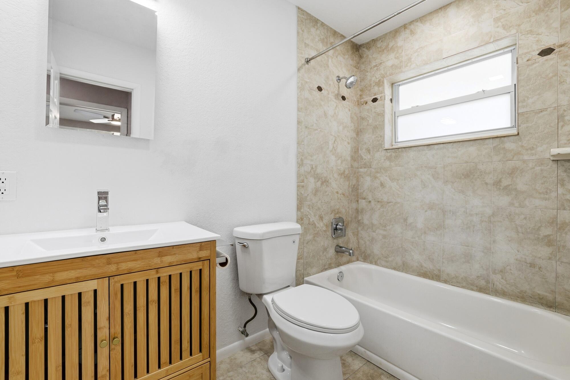 301 Wilma Circle Riviera Beach, FL 33404 - Photo 13 of 35 a bathroom with a sink toilet and bathtub