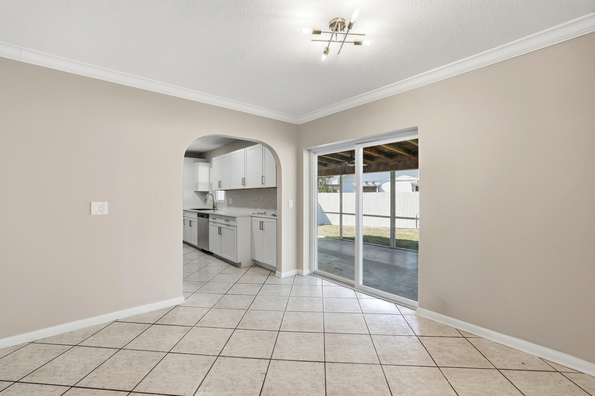 301 Wilma Circle Riviera Beach, FL 33404 - Photo 6 of 35 a view of a livingroom with a chandelier fan and windows