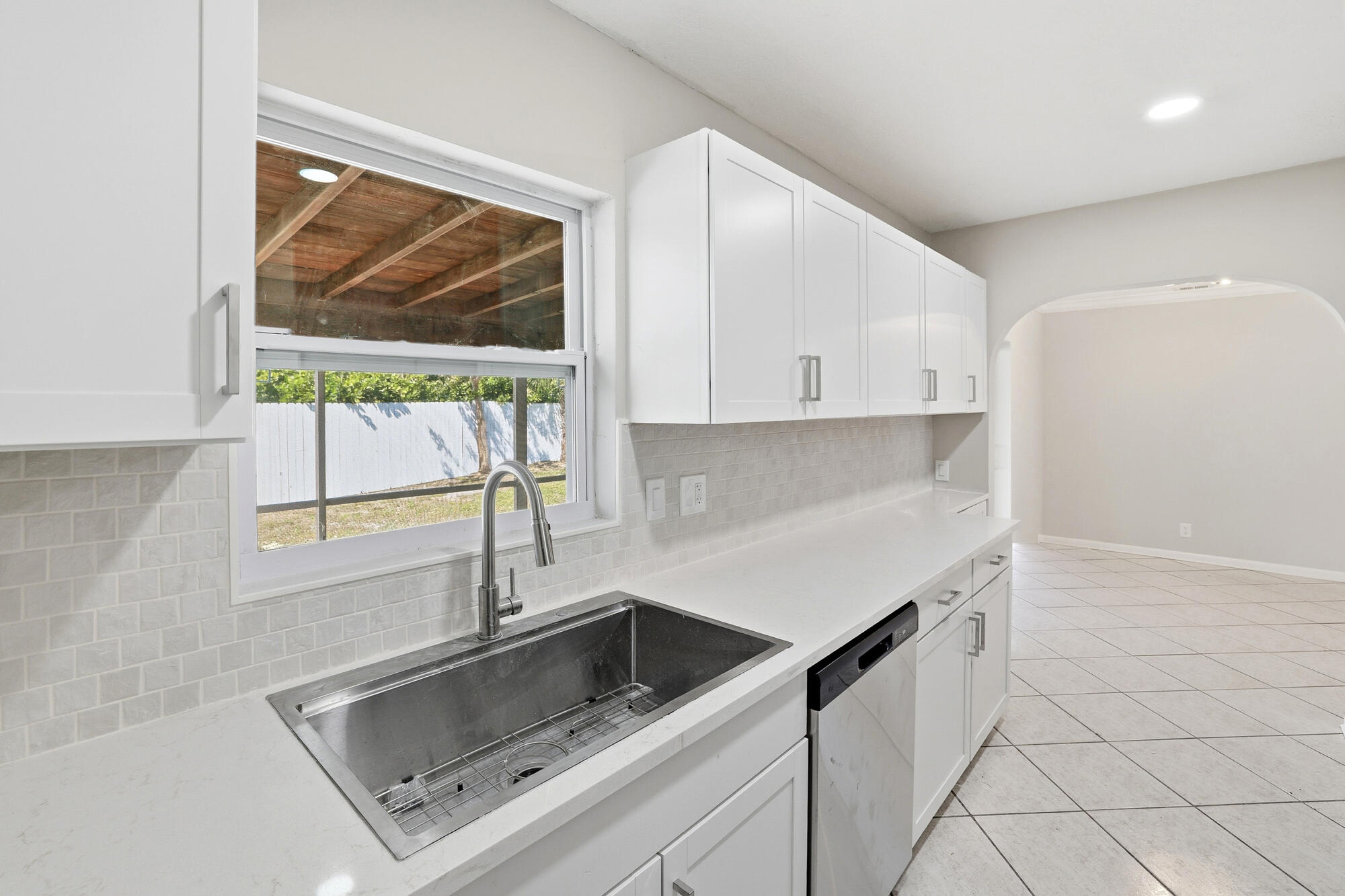 301 Wilma Circle Riviera Beach, FL 33404 - Photo 9 of 35 a kitchen with a sink cabinets and window