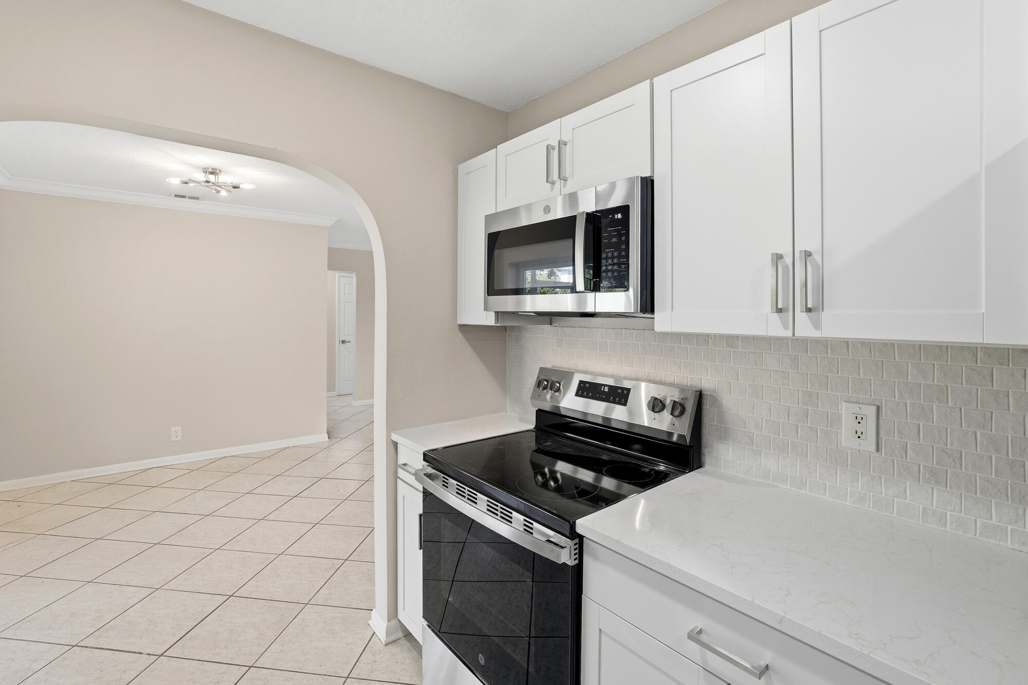 301 Wilma Circle Riviera Beach, FL 33404 - Photo 10 of 35 a kitchen with a stove and a microwave