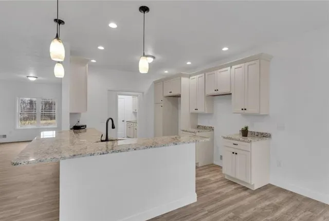 a kitchen with kitchen island a sink stainless steel appliances and cabinets