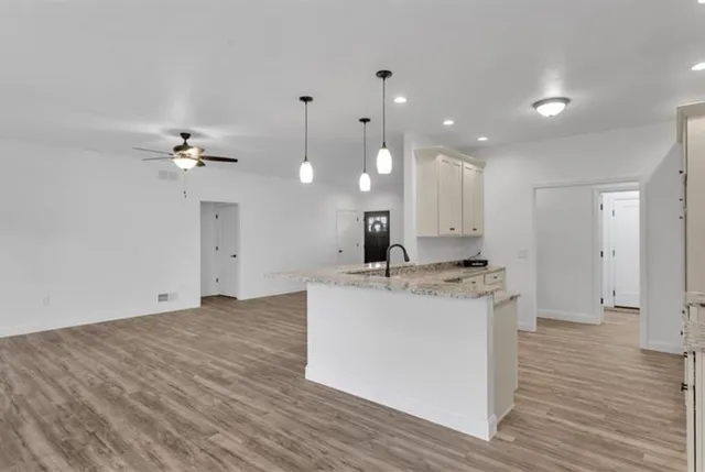 a view of a kitchen with a sink and wooden floor