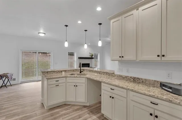 a kitchen with stainless steel appliances granite countertop a sink a stove and a refrigerator