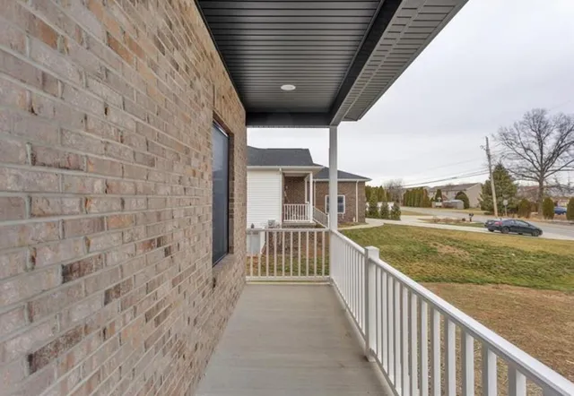 a view of a porch with wooden floor and fence