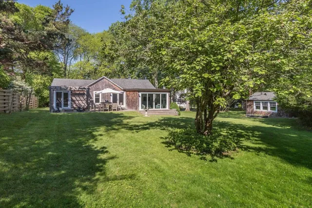a house with green field in front of it