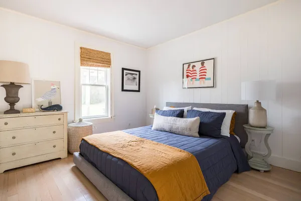 a bedroom with a bed and window