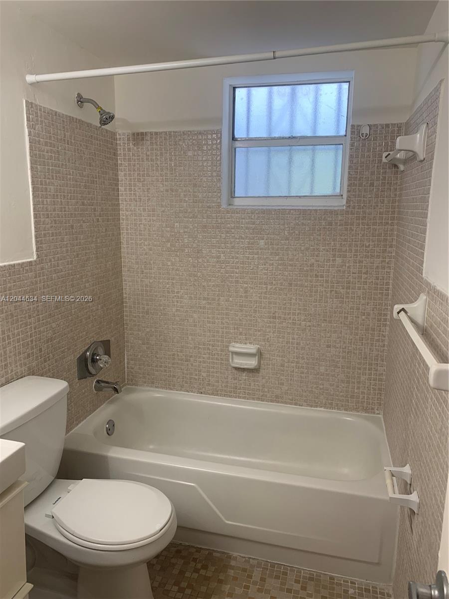 2460 Southwest 18th Avenue, Unit 1205 Miami, FL 33133 - Photo 17 of 21 a bathroom with a toilet and a bath tub