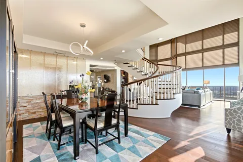 a view of a dining room and hall with furniture