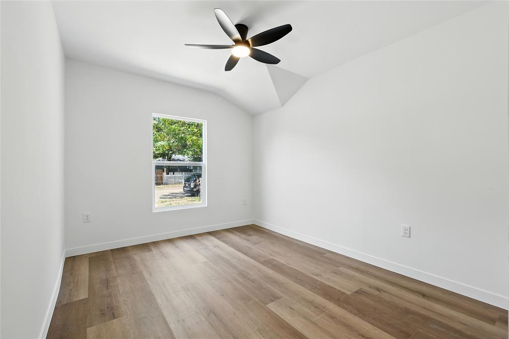 3122 Seevers Avenue Dallas, TX 75216 - Photo 11 of 16 an empty room with wooden floor and windows