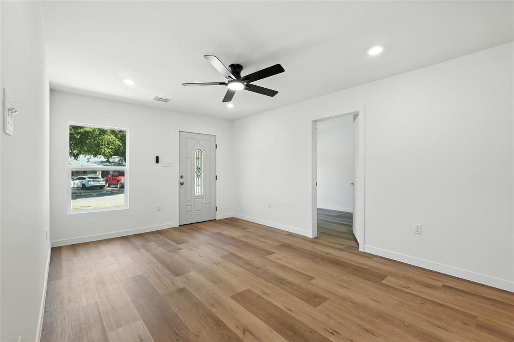 3122 Seevers Avenue Dallas, TX 75216 - Photo 5 of 16 an empty room with wooden floor and windows
