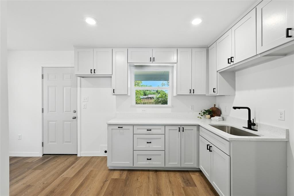 3122 Seevers Avenue Dallas, TX 75216 - Photo 6 of 16 a kitchen with white cabinets and window