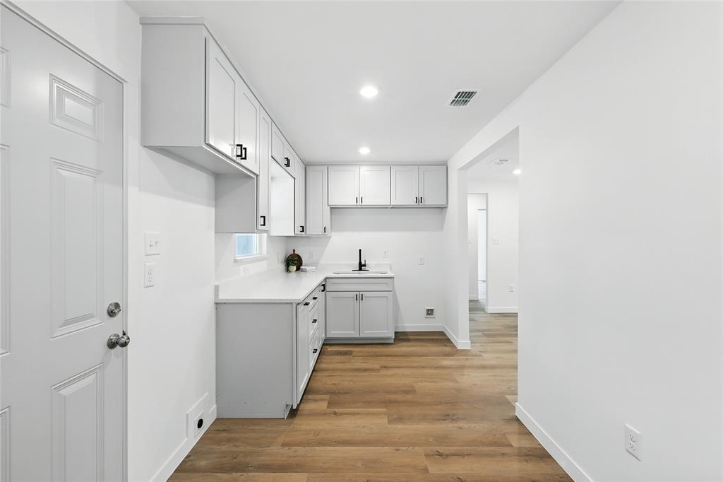 3122 Seevers Avenue Dallas, TX 75216 - Photo 7 of 16 a view of a kitchen with white cabinets