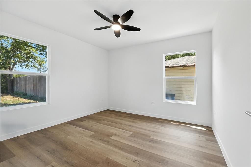 3122 Seevers Avenue Dallas, TX 75216 - Photo 9 of 16 an empty room with a window and a ceiling fan