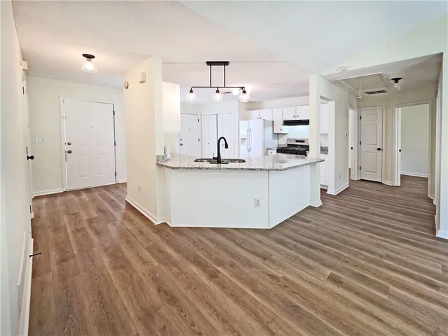 a kitchen with stainless steel appliances granite countertop a sink stove and refrigerator
