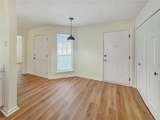 a view of an empty room and wooden floor