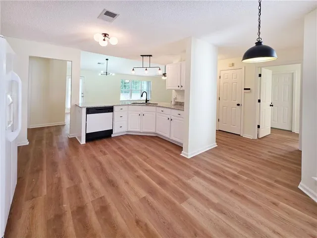a kitchen with stainless steel appliances a refrigerator and a stove top oven
