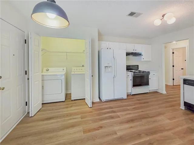 a view of a kitchen with a stove cabinets and wooden floor