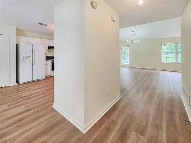a view of hallway with wooden floor