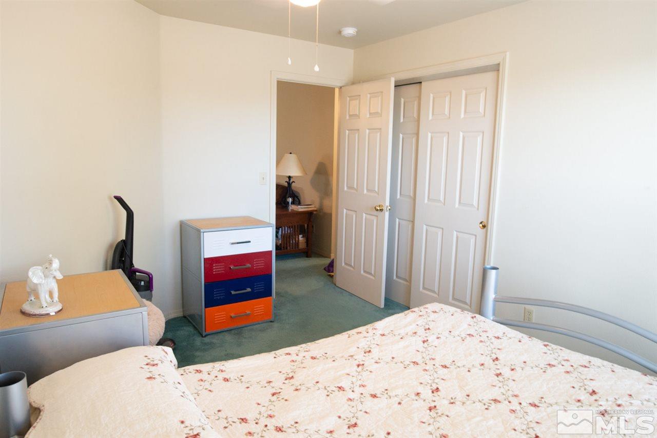 4080 Rancheria Road Fallon, NV 89406 - Photo 16 of 25 a bedroom with a bed and a couch