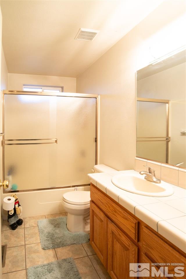 4080 Rancheria Road Fallon, NV 89406 - Photo 17 of 25 a bathroom with a sink a toilet and mirror