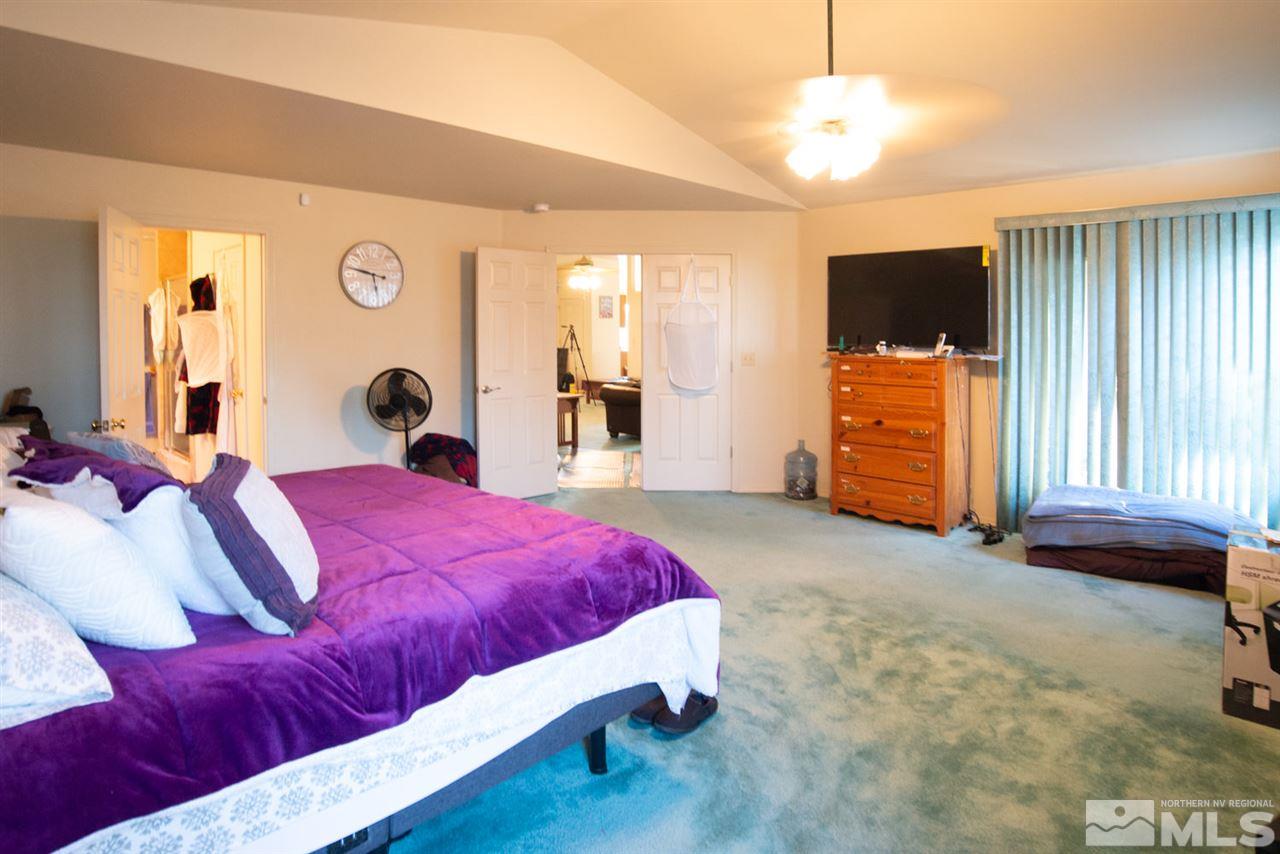4080 Rancheria Road Fallon, NV 89406 - Photo 19 of 25 a living room with a bed furniture and a flat screen tv