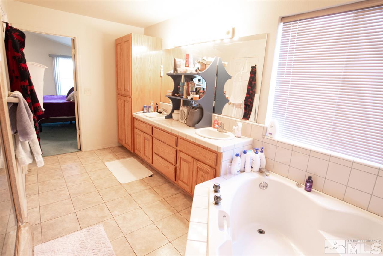 4080 Rancheria Road Fallon, NV 89406 - Photo 20 of 25 a bathroom with a tub sink and mirror