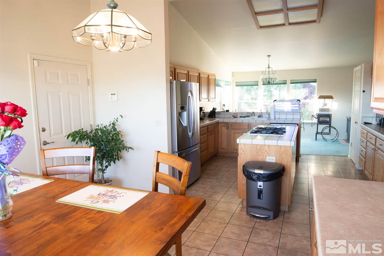 4080 Rancheria Road Fallon, NV 89406 - Photo 10 of 25 a living room with furniture a dining table and a chandelier