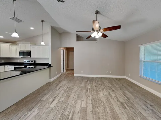 a view of kitchen with sink microwave and stove