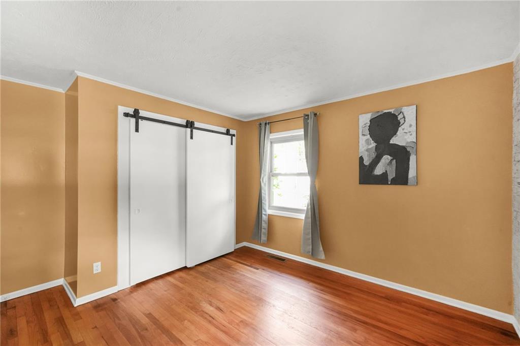 2570 Spring Drive Smyrna, GA 30080 - Photo 22 of 41 a view of empty room with wooden floor and fan