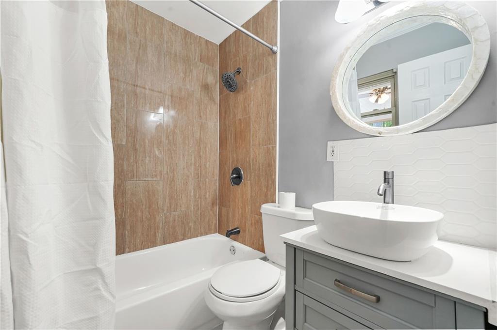 2570 Spring Drive Smyrna, GA 30080 - Photo 26 of 41 a bathroom with a toilet a sink and a mirror