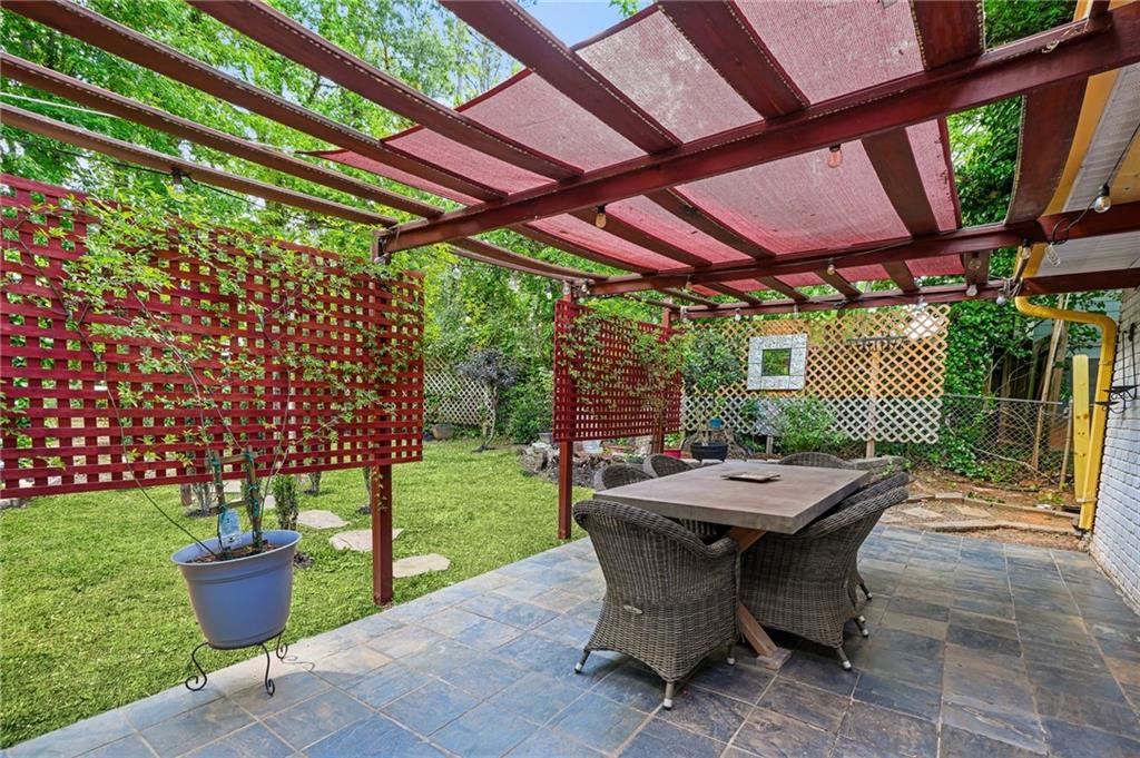 2570 Spring Drive Smyrna, GA 30080 - Photo 35 of 41 a view of a patio with a table and chairs and a barbeque