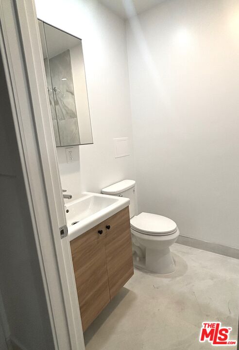 2115 Venice Blvd., Unit 1/2 Los Angeles, CA 90006 - Photo 12 of 14 a bathroom with a toilet a sink and mirror