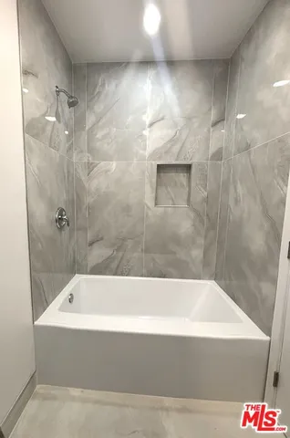 a bathroom with a bathtub and shower