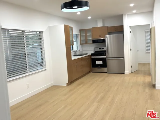 a kitchen with stainless steel appliances a refrigerator and a stove top oven