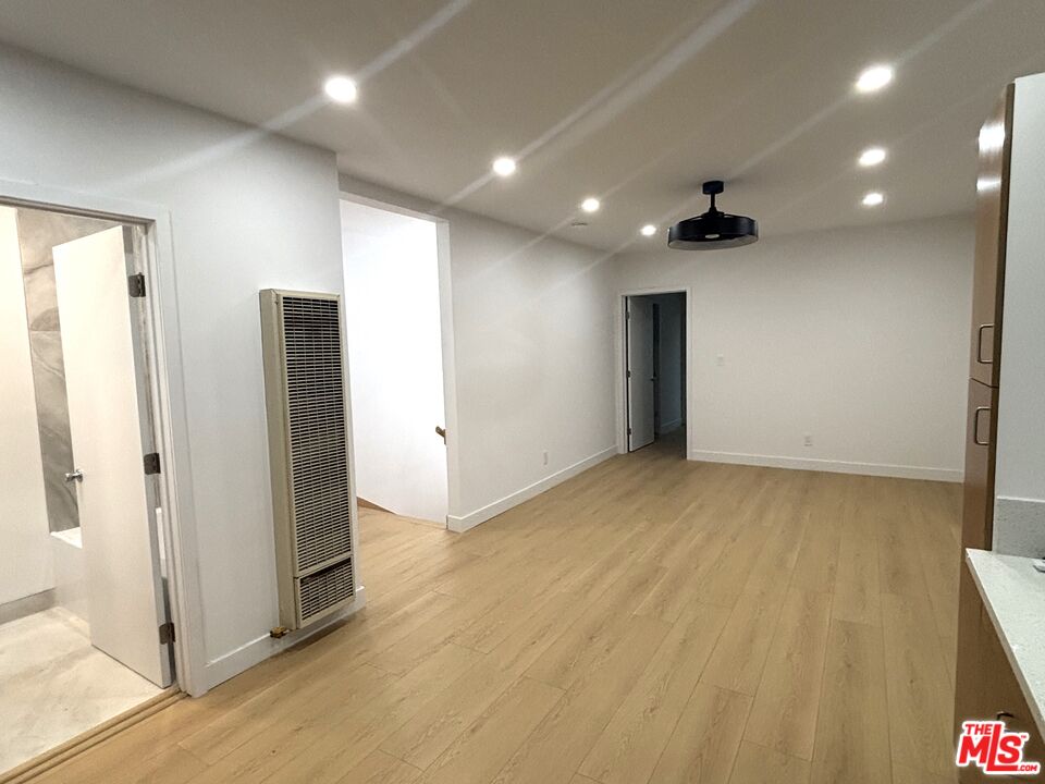 2115 Venice Blvd., Unit 1/2 Los Angeles, CA 90006 - Photo 6 of 14 an empty room with wooden floor and entrance
