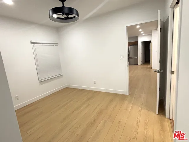 an empty room with a empty space and chandelier fan