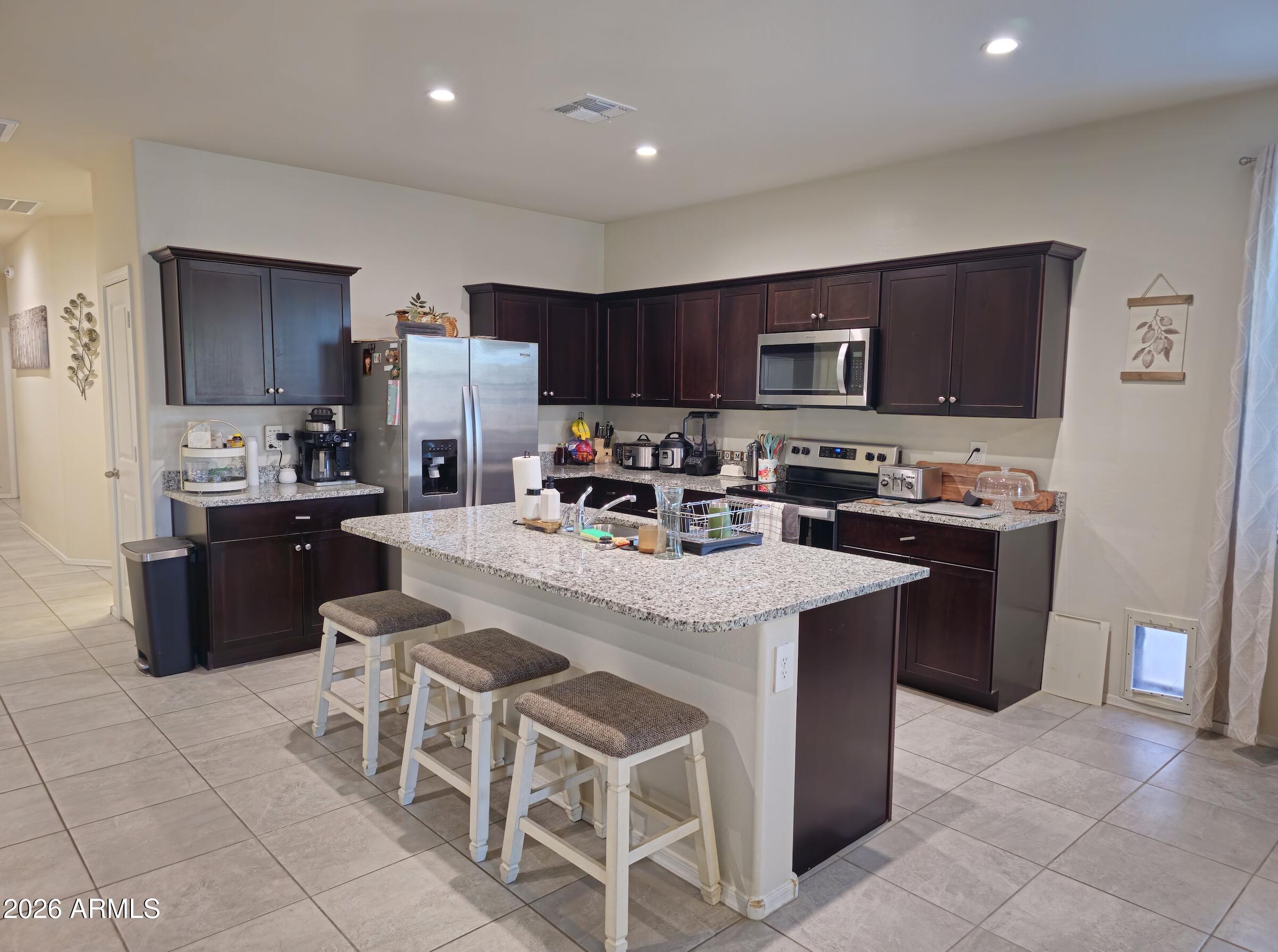 9434 Cotton Road Florence, AZ 85132 - Photo 6 of 25 a kitchen with stainless steel appliances granite countertop a stove a sink a refrigerator a microwave and a refrigerator