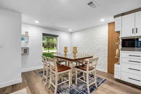 a view of a dining room with furniture and a window