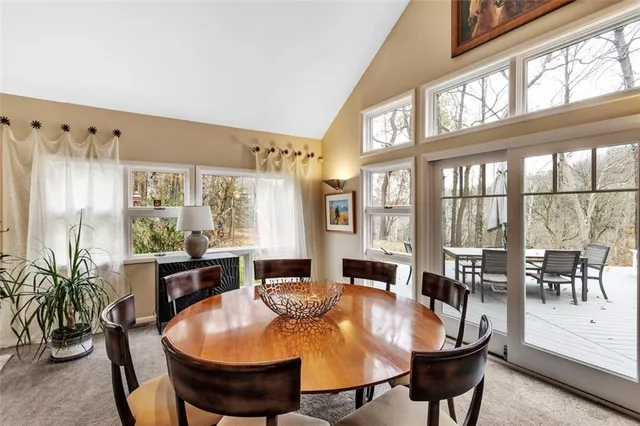 a view of a dining room with furniture large windows and wooden floor