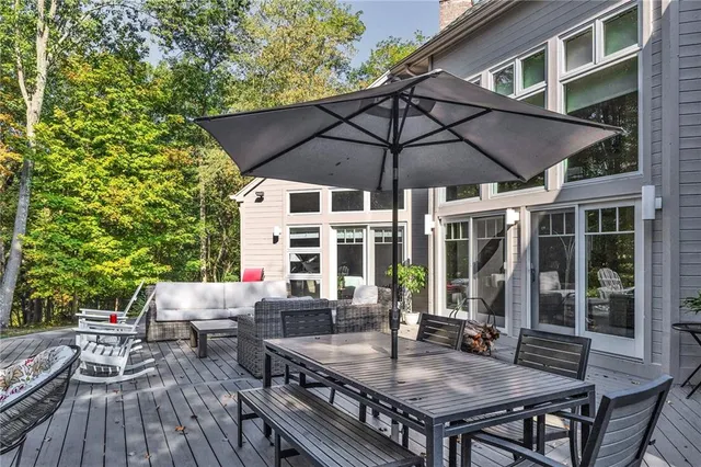 a view of house with backyard and sitting area