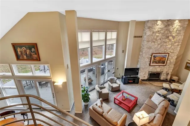 a living room with furniture and a floor to ceiling window