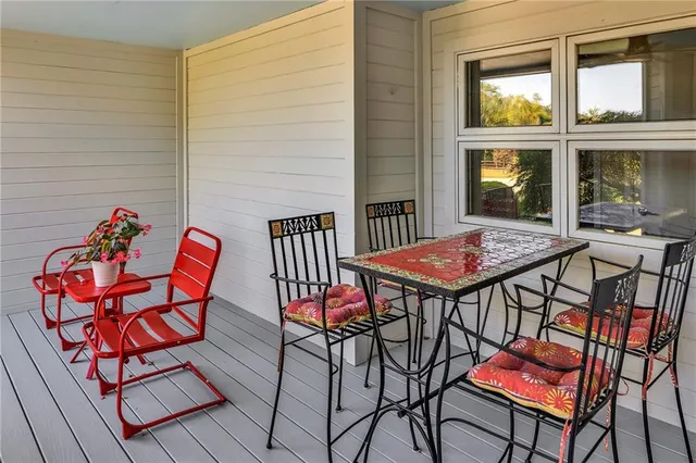 a view of a chairs and table in the balcony