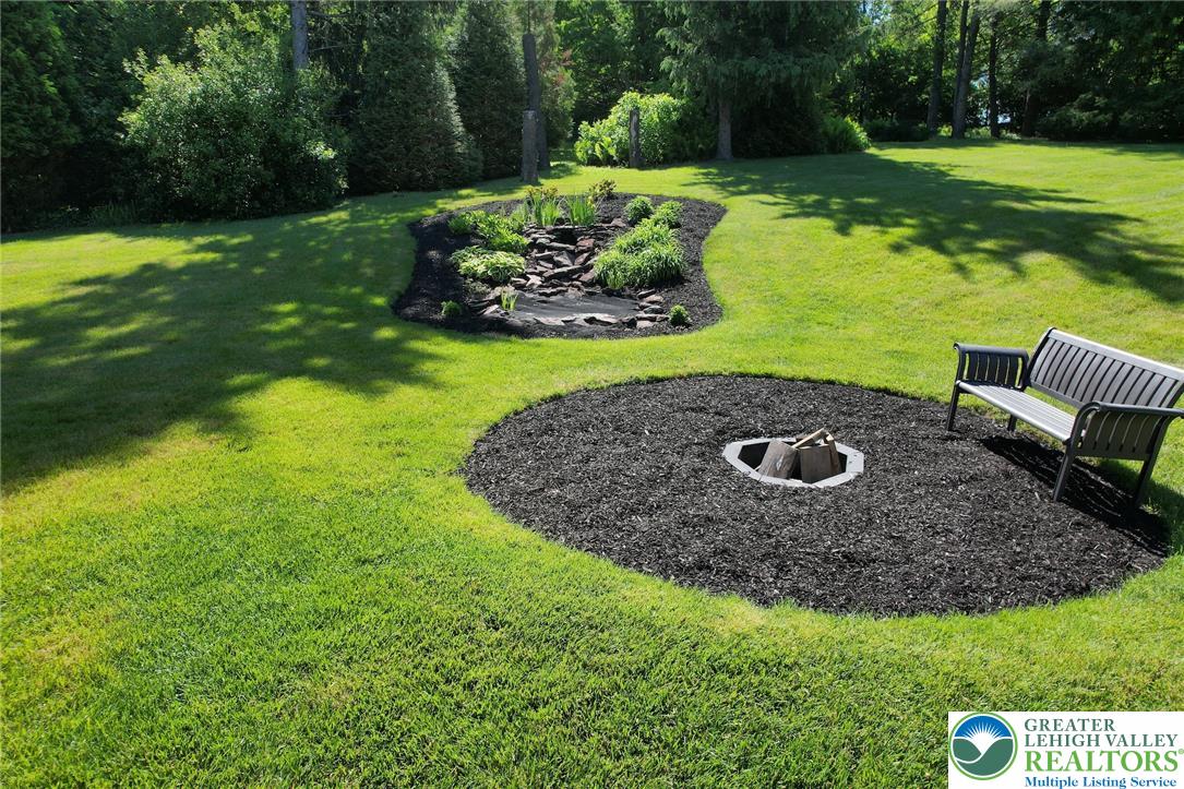 3470 Brodhead Road Bethlehem, PA 18020 - Photo 26 of 84 A tranquil garden oasis features a charming fire pit, inviting outdoor relaxation.