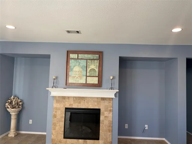 a living room with furniture and large windows