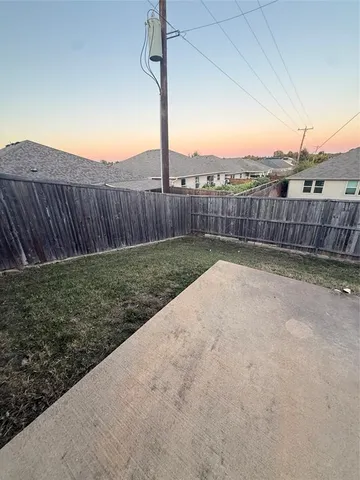 a view of a backyard with a fence